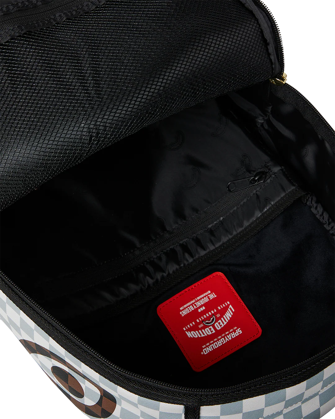 Zipped Open View of the Sprayground Cream And Brown Tear Check Backpack