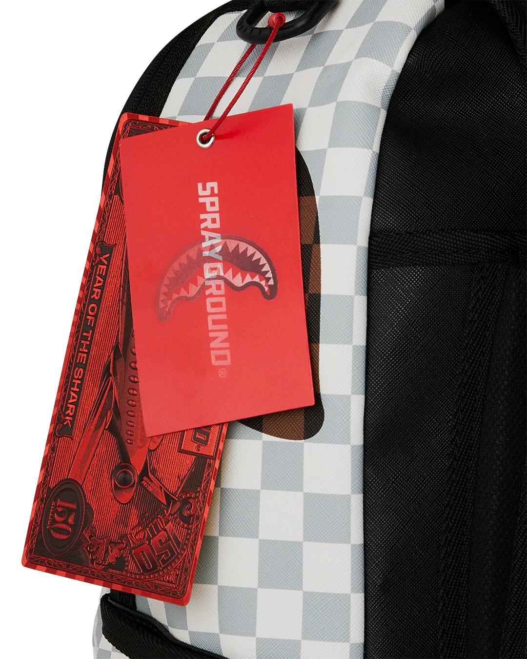 Spraygroung Tag View of the Sprayground Cream And Brown Tear Check Backpack