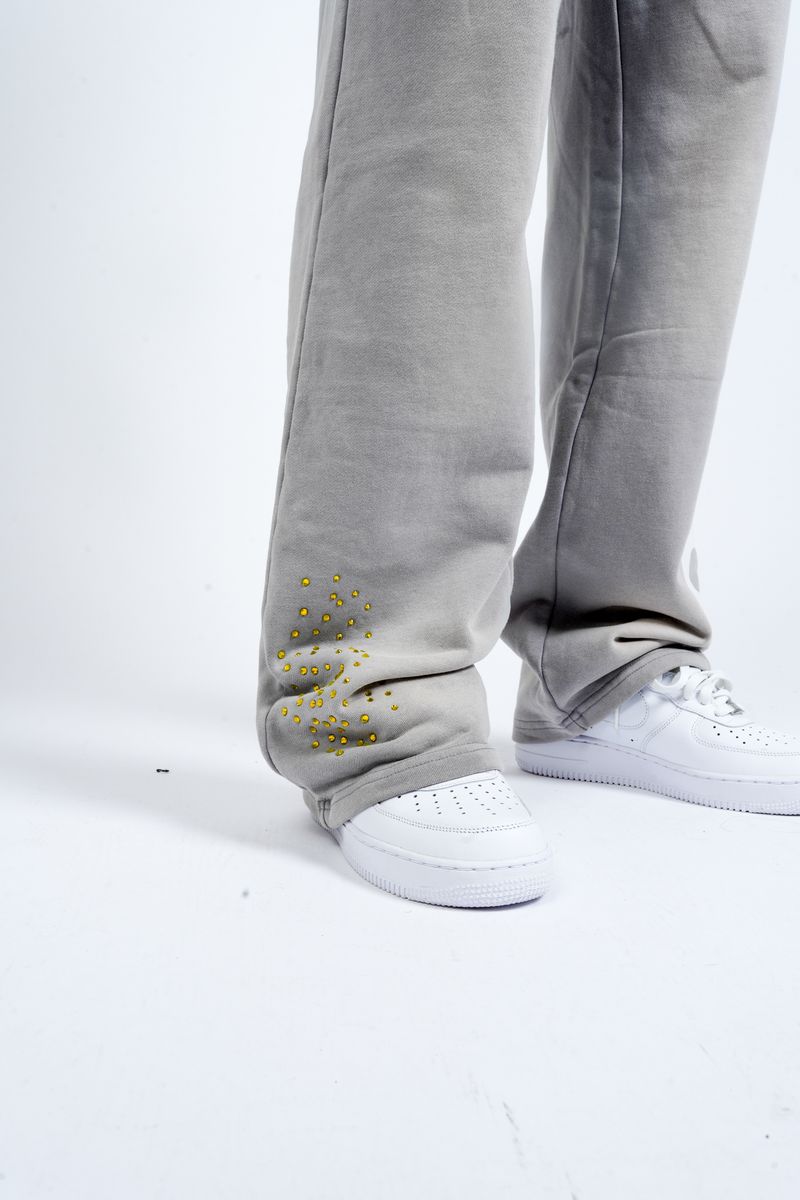 Close-Up View of the Yellow Rhinestones on the Paper Money PAPER SWEATPANTS in Grey